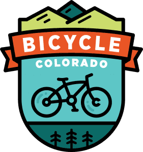 Cycling badge with trees and mountains