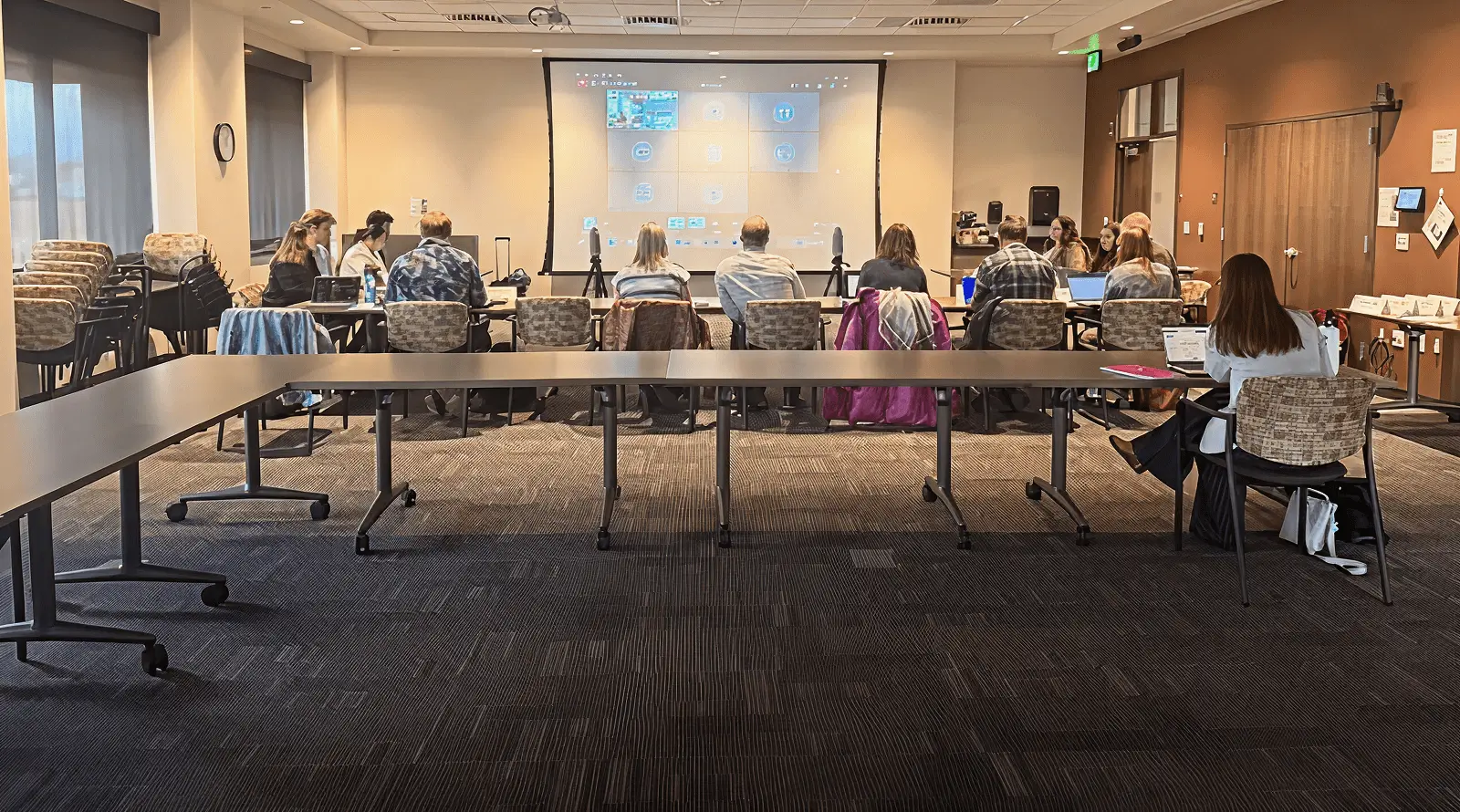 People attending classroom-style meeting